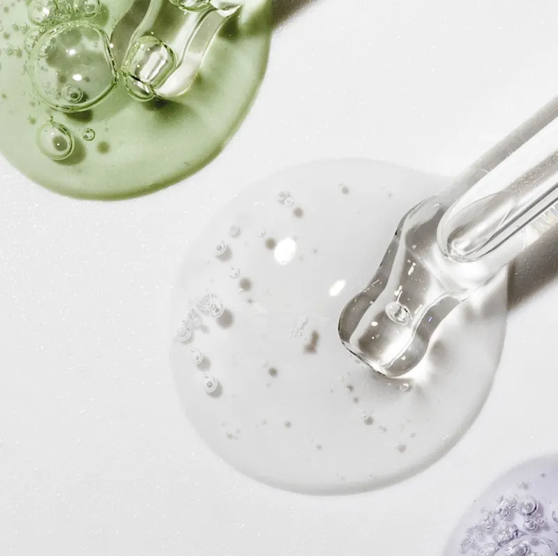 Drops of esthemax® gel and serum with a dropper on a white background